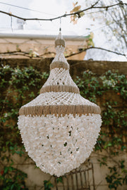 A truly exceptional piece, these chandeliers are hand made using hundreds of tiny white shells twined together on a wrought iron base. Iridescent sea Perth Fremantle