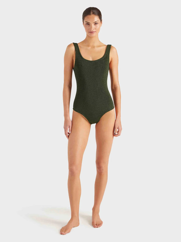 Woman wearing a green swimsuit on a white background HUNZA G Coverage Square Neck Swimsuit in Metallic Khaki Iridescent sea Fremantle