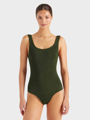 Woman wearing a green swimsuit on a white background HUNZA G Coverage Square Neck Swimsuit in Metallic Khaki Iridescent sea Fremantle