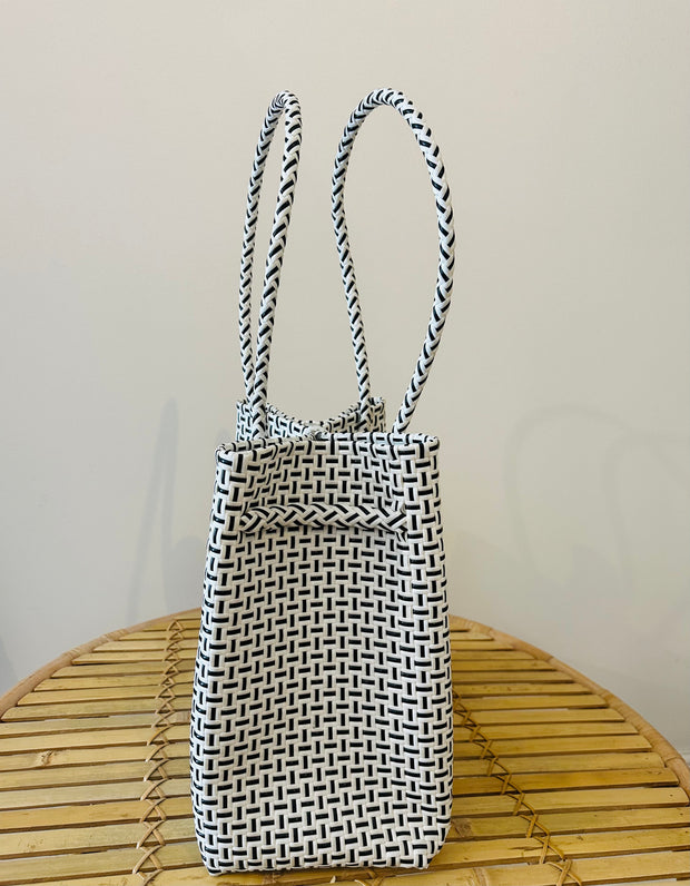Carry your beach essentials in style with this Black and White Basket. Made of durable plastic, it's perfect for a day at the beach. No more messy totes, this sturdy basket is a must-have for any beach trip. Can also double as a chic market tote. Iridescent sea South Fremantle