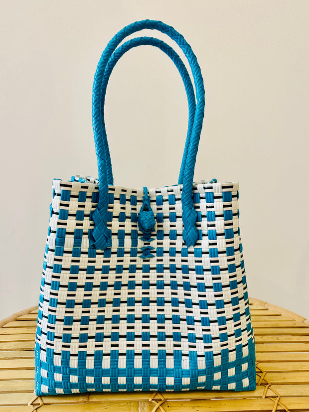 Carry your beach essentials in style with this Blue &amp; White &nbsp;Basket. Made of durable plastic, it's perfect for a day at the beach. No more messy totes, this sturdy basket is a must-have for any beach trip. Can also double as a chic market tote. Iridescent Sea Fremantle