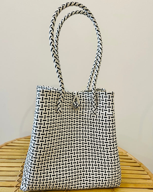 Carry your beach essentials in style with this Black and white Basket. Made of durable plastic, it's perfect for a day at the beach. No more messy totes, this sturdy basket is a must-have for any beach trip. Can also double as a chic market tote. Iridescent sea South Fremantle