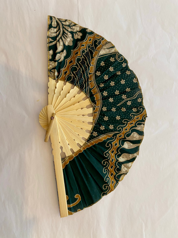 Decorative hand fan with green and gold pattern on a white background Iridescent sea Fremantle