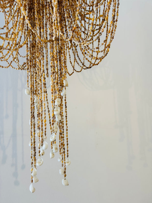 A truly exceptional piece, these chandeliers are hand made using hundreds of tiny speckled brown shells twined together on a wrought iron base. Iridescent sea Perth Fremantle