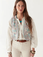 Woman wearing a patterned vest over a white shirt with a plain background.
 Karina Vest- Maison Hotel at Iridescent sea Perth