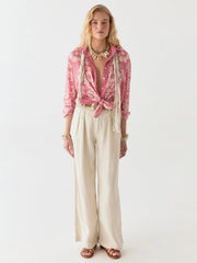 Woman wearing a pink checkered shirt and beige pants on a white background MAISON HOTEL Rusty Blouse in Pink Floyd Iridescent Sea Fremantle
