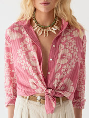 Pink floral blouse with a tied front, worn by a person, on a white background MAISON HOTEL Rusty Blouse in Pink Floyd Iridescent Sea Fremantle