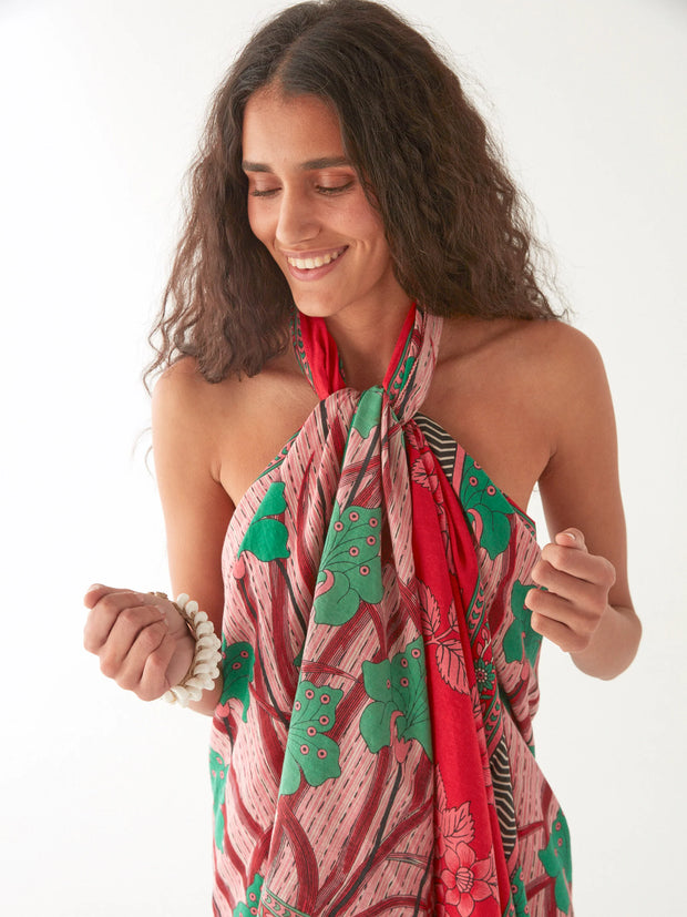 Woman wearing a red and green patterned halter top against a white background Maison Hotel  Nestor Pareo in Camelia Carmine. Iridescent sea Fremantle australia