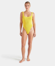Woman wearing a white swimsuit against a plain background HUNZA G Square Neck Swimsuit in Sunflower Iridescent Sea Fremantle