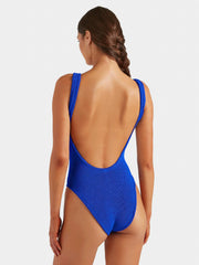 Woman wearing a white swimsuit against a plain background HUNZA G Square Neck Swimsuit in Royal Blue Iridescent Sea Fremantle