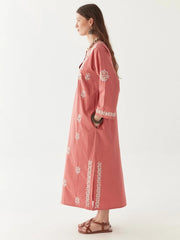 Woman wearing a pink embroidered dress on a white background MAISON HOTEL Anbu Dress - Chikan Corallo Iridescent sea Fremantle Perth