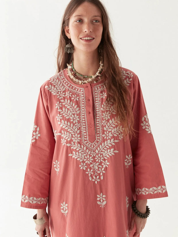 Woman wearing a pink embroidered dress on a white background MAISON HOTEL Anbu Dress - Chikan Corallo Iridescent sea Fremantle Perth