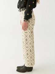 Person wearing a black shirt and patterned pants on a white background MAISON HOTEL Lula Pant in Java Vanilla Iridescent sea Perth Fremantle