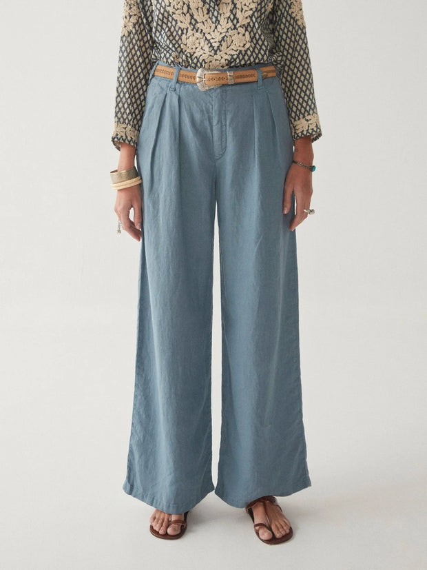 Person wearing a patterned top and blue wide-leg pants on a plain background MAISON HOTEL Marisa Pant in Berenson Petroleo Iridescent Sea Fremantle Perth